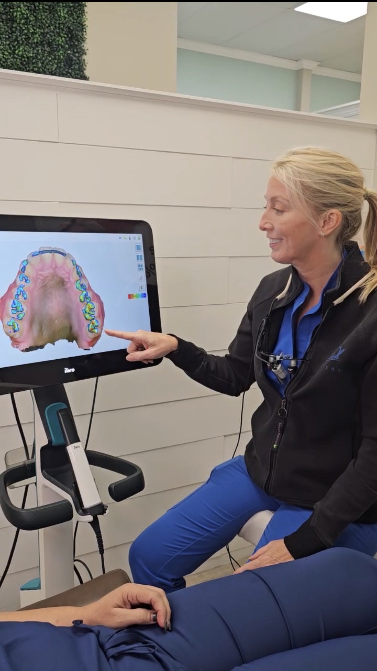 Dr. Shah reviewing digital X-rays and iTero scan images with a patient